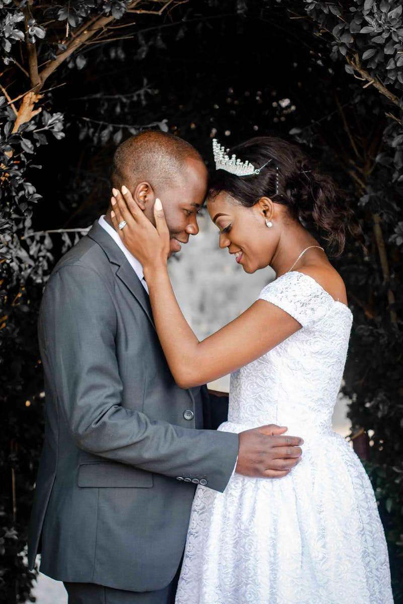 A loving couple shares a tender moment in a beautiful garden wedding ceremony.
