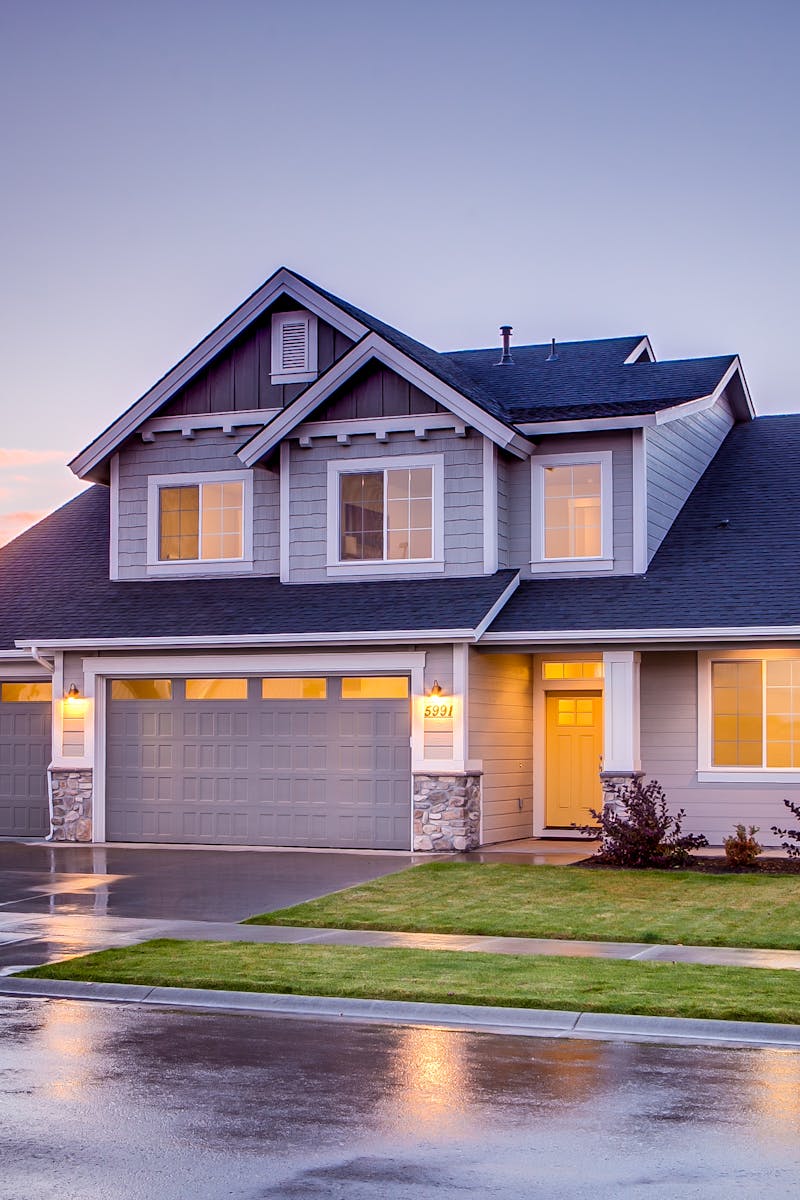 Elegant suburban home with driveway at sunset showcasing modern architecture.