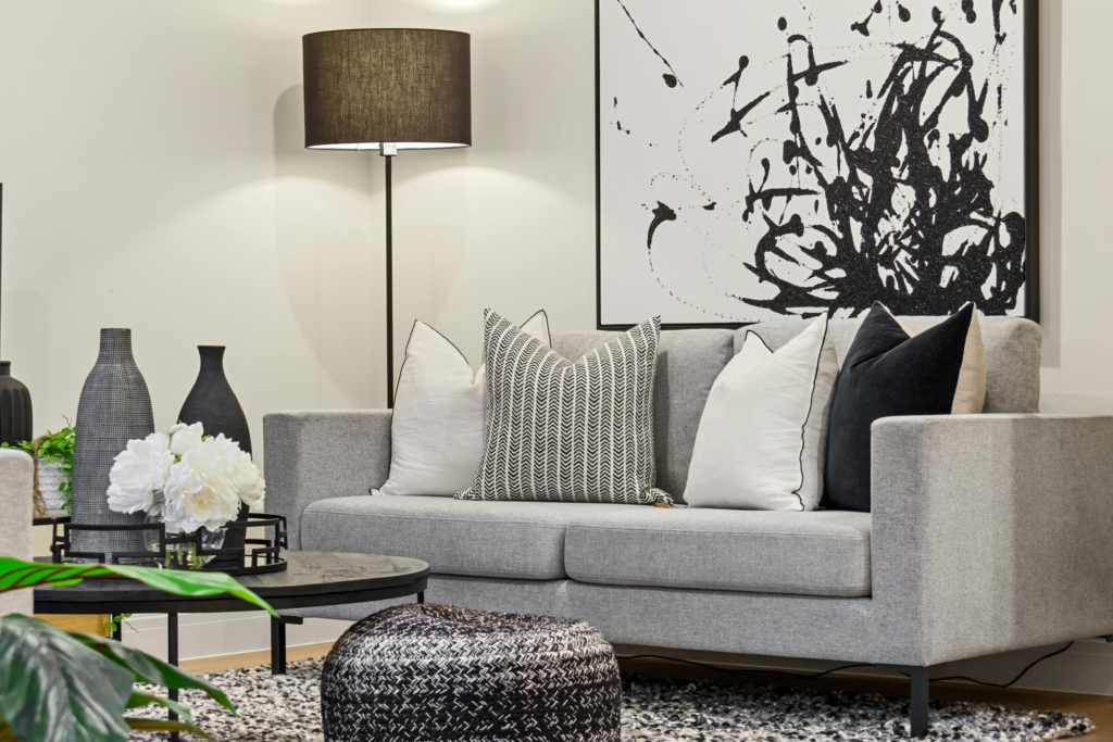 A stylish grey living room featuring abstract artwork, a modern couch, and elegant decor.